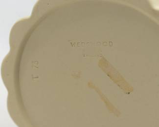 Closeup of the A Wedgwood Primrose yellow Jasperware covered sugar jar and pair of candlesticks from the bamboo or cane ware pattern. Crafted with a vertical bamboo stalk design as the body of the pieces, with small applied terracotta colored leaves emanating from each of the indentions representing joints. The lidded sugar jar 4.5” H x 3.5” W, candlesticks 4.5” H x 2.5” widest part.