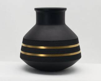 Wedgwood Black Basalt Brutalist Vase 1969 Robert Minkin. This vintage Wedgwood Black Basalt stoneware vase 'Design for Today' was designed by Robert Minkin and Peter Wall for Josiah Wedgwood and Sons in 1966-67. Expertly crafted of Wedgwood’s “Black Basalt” stoneware and finished with bands of texture and of gilding, the perfect proportions measure 5” H x 5” W. Impressed marks to the base of “WEDGWOOD” “MADE IN ENGLAND” “69” and “M”. An example of this vase resides in the collection of the Victoria and Albert Museum in London.
Josiah Wedgwood developed the popular Black Basalt in 1768. Walter Robert Minkin (1928–2012) was a British Postwar & Contemporary artist who joined Wedgwood in 1955, and became Design Director in 1979.