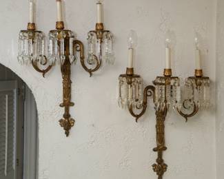 Fabulous pair of antique electrified gilt bronze three-light sconces with prisms