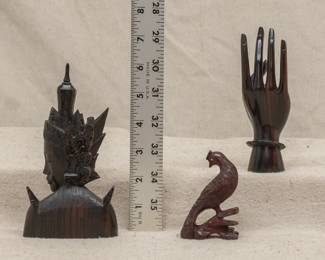 Another view of the vintage Indonesian carved wooden figures of a deity, a graceful open hand, and a bird
