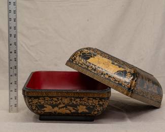 Another view of the fine vintage Chinese export black lacquer carved box with gilt painted detailing of peony scrolls and a central panel of flying phoenix birds; the interior of the box painted oxblood red  