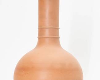 A large mid-19th century Wedgwood Rosso Antico bottle vase, a graceful classic form unadorned but for two raised horizontal rings around the lower neck. Unglazed and showing the fine grain of the material. 11” H. 

Rosso Antico, Italian for “old red,” came about in 1765, when Wedgwood started experimenting with limited batches of the redware; in 1776 he resumed production of Rosso Antico per suggestion of Thomas Bentley, and this time around it continued until the twentieth century.