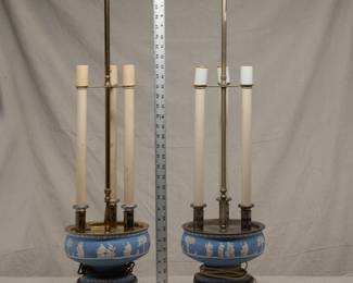Bring some antique elegance to your home with this pair of 1920's Wedgwood candelabra lamps. Blue Jasperware with neoclassical decoration, one with silverplated fittings and one with brass fittings. 