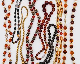 A variety of autumn color beaded necklaces, satin finish gold beads, tortoiseshell style beads, gold metal chain links with rich pumpkin color beads, faceted dark brown crystal beads, perfect for fall and winter outfits