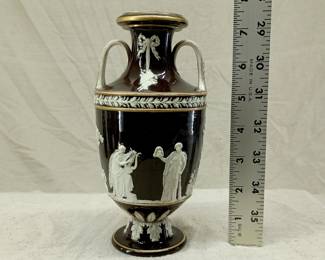 Antique 1850's Wedgwood black dip jasper ware double handled urn shaped vase with applied classical figures in white relief depicting the muses of comedy/drama, music, poetry; covered overall in a shiny clear glaze and with applied gilding. Wedgwood stamp to the base along with group of 4 "mustache" marks, and hand-incised numerals 350. See example in of this vase in the Nelson Provincial Museum, Australia.