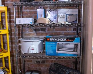 Kitchen wares including a Black and Decker Toast-R-Oven Classic, a coffee maker, a wide slot toaster, crock pot, thermal carafe