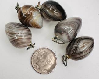 A group of polished agate pendants