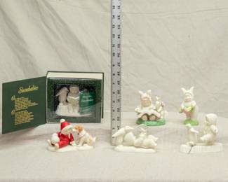 A set of winter holiday Snowbabies porcelain figurines by Department 56 including Babies Best Friend, Perfect Balance, A Bunny Tale, and You're the Pick of the Pack