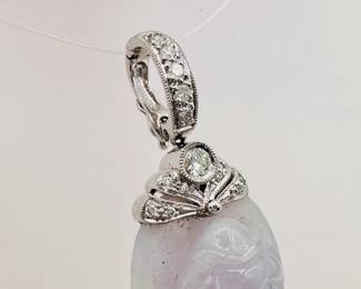 Closeup of the carved lavender jade Guanyin pendant mounted in 18k white gold with diamonds