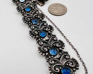 Another view of the rare and gorgeous 1950s vintage Margo de Taxco sterling silver and blue stone bracelet, curving scrolled and beaded links set with blue stones. Marked Margot de Taxco, design #5302, eagle 16, Sterling Made in Mexico.