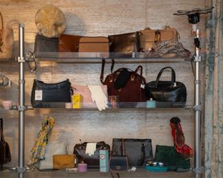 A variety of vintage leather handbags and purses, along with vintage silk scarves, ladies gloves, and more