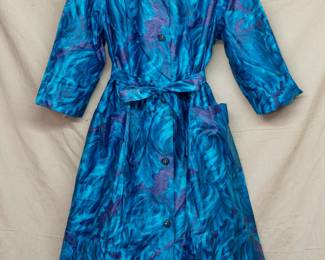 A darling vintage A-line belted dress in swirling rich blues and violet pattern, rhinestone button front and with pockets; label reads Styled by Saybury 