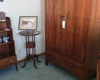 The wardrobe features a shelf and three long drawers just behind the doors along with the two smaller drawers below.