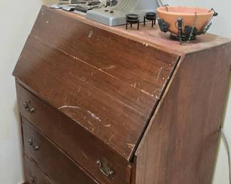 This slant front desk is a repair job and is priced accordingly. Basement hallway.