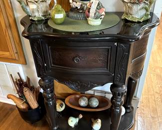 antique table and teapots and decorator items