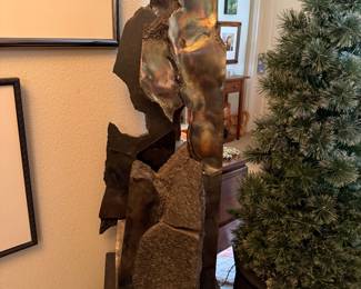 #16 - $2,200 - Sid Kamerman (Born in NY 1943-2016)"Primordial soup" 38x12x16 The metal and rock represent early Earth of 4+ billion years ago, referencing geology and evolution, these essential elements and ingredients are considered building blocks of fire.