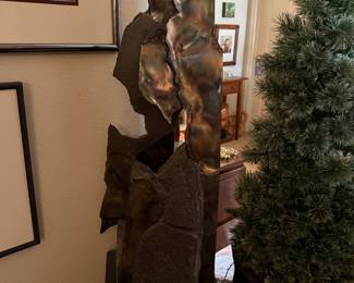 #16 - $2,200 - Sid Kamerman "Primordial soup" 38x12x16 The metal and rock represent early Earth of 4+ billion years ago, referencing geology and evolution, these essential elements and ingredients are considered building blocks of fire.