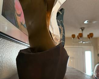 #15 - $1,200 - Sid Kamerman (Born in NY 1943-1943-2016)"Sacred & Secular" 12x9 Highly polished Wyoming jade, polished stai nless steel, and bronze characterize this unique sculpture symoblizing ancient values and power to modern function and durability. 