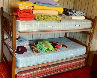 Bunk beds with trundle,  blankets and afghans 
