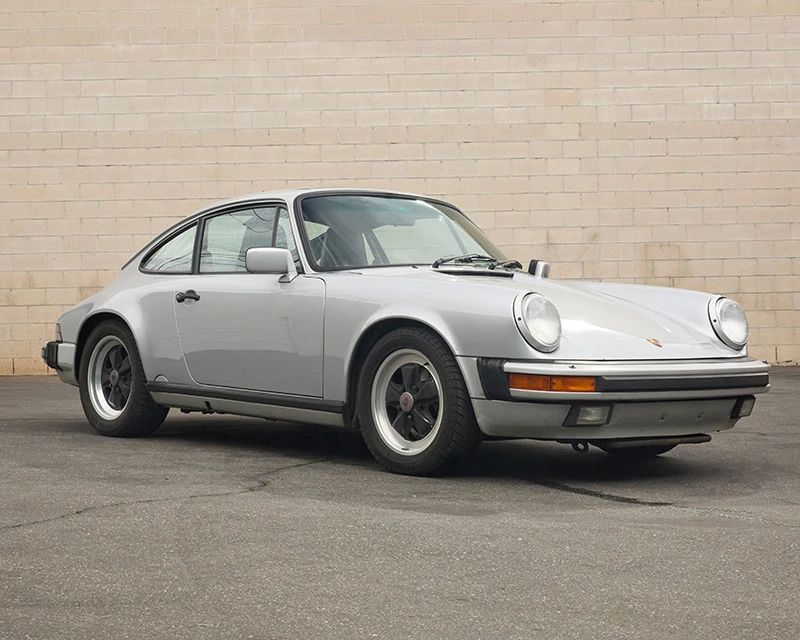 1
A 1988 Porsche 911 Carrera
Numbered to engine block: 64105114
VIN: WP0AB0913JS121508; Plate: 2JNN171
Silver exterior, interior with black leather
105,9XX miles
3.2 liter, flat 6 engine
5-speed manual transmission, rear-wheel drive
Blaupunkt radio and tape player
Functional sunroof
Porsche manuals included as well as a Porsche brand tire air compressor
Estimate: $20,000 - $30,000