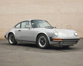 1
A 1988 Porsche 911 Carrera
Numbered to engine block: 64105114
VIN: WP0AB0913JS121508; Plate: 2JNN171
Silver exterior, interior with black leather
105,9XX miles
3.2 liter, flat 6 engine
5-speed manual transmission, rear-wheel drive
Blaupunkt radio and tape player
Functional sunroof
Porsche manuals included as well as a Porsche brand tire air compressor
Estimate: $20,000 - $30,000