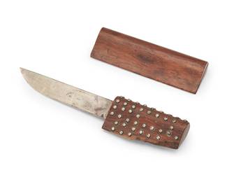 12
Jean E. Puiforcat (1887-1945)
A sterling silver letter opener, circa 1942-1945
Blade marked: ['JP' cipher] / Jean Puiforcat / Made in Mexico
The blade set in a carved mahogany handle, the sheath with live edge segment, mounted with sterling silver dot accents
Overall: 8" L x 1.625" W x 0.75" D; Blade: 4.625" L
Estimate: $600 - $800