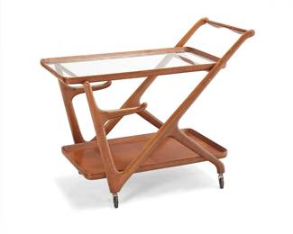 58
Cesare Lacca (1913-1978)
A bar cart for Cassina, mid-20th century
Unmarked
The wood Z-form cart with shaped push bar and glass top above arms for a removeable serving tray, raised on casters
28" H x 34" W x 17.5" D
Estimate: $500 - $700