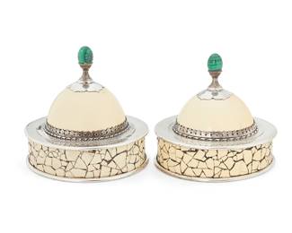 219
Anthony Redmile (1940-2016)
A pair of ostrich egg boxes, circa 1980s
Each marked to the interior liner and finial: redmile London
Each silver-plated round box mounted with ostrich egg shards to the side, the ostrich half egg lid mounted with silver-plated trimmings and a malachite finial
2 pieces
Each: 6.75" H x 7.25" Dia.
Estimate: $700 - $900