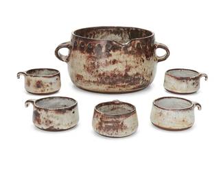 202
A glazed studio pottery soup crock and bowls
Mid-20th century
Each impressed with yet to be known artist's chop mark
Comprising a soup pot with pour spout and opposed lug handles, and four individual soup cups with handles
6 pieces
Crock: 6.75" H x 14.75" W x 11.75" D; Each cup: 2.625" H x 5.125" W x 4.625" D approximately
Estimate: $300 - $500