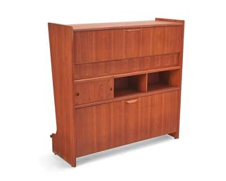 27
Johannes Andersen (1903-1991)
A teak standing dry bar model SK 661 for Skaaning, mid-20th century
Unmarked
The front with a brushed steel footrest, the back with flip-top bar surface and drop-shelf work surface, opening to reveal a small glass shelf and nine bottle niches, above three cubbies and a sliding cabinet door, above a lean-out lower well with nine more bottle niches
44.5" H x 46" W x 16.25" D
Estimate: $1,000 - $2,000
