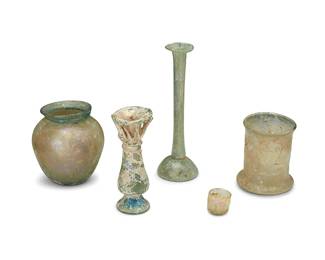 330
A group of Classical iridescent glass vessels
Circa 100-500 CE
Comprising a cup, two footed vessels, a vase, and a small thimble-sized vessel
5 pieces
Tallest: 6.875" H x 2.25" Dia.; Smallest: 1" H x 1.125" Dia.
Estimate: $500 - $700