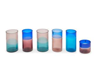 340
A group of Venini Murano glassware items for Hughes Airwest
1973-1983
All but four etched: Venini / Italia; of those, thirteen are dated and personalized: 73; the rest dated: 83; some with original Venini sticker applied; the remaining four unmarked
The assembled group comprising 15 tall glasses, 11 tumblers, and 4 associated glasses in conforming style, two with a varied colorway, commissioned by Mario Armond Zamparelli and Company
30 pieces
Taller: 5.625" H x 2.75" Dia.; Shorter: 2.875" H x 2.875" Dia.; Forms: 4.75" H x 12.5" W x 14.75" D
Estimate: $500 - $700
