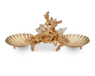225
Claude Victor Boeltz (b. 1937)
A gold-plated nickel vide poche, late 20th century
Marked in the casting to underside: Made in France / Boeltz / Paris
The two-compartment trinket dish featuring a coral-form center mounted with quartz crystals and issuing opposed scallop shell-form dishes
5.125" H x 11.875" W x 4.875" D
Estimate: $200 - $400