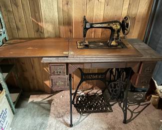 Very old Singer Treadle Sewing Machine with table and all the accessories. Four drawers that all open easily.