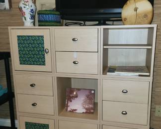 This is an IKEA KALLAX shelving unit with door and drawer inserts