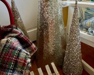 3 Gold tone Christmas trees - chair in the background in not for sale 