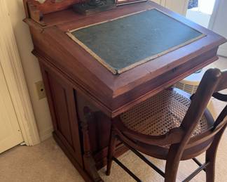 Captain's desk with felt top. Lifts for storage and drawers on side.