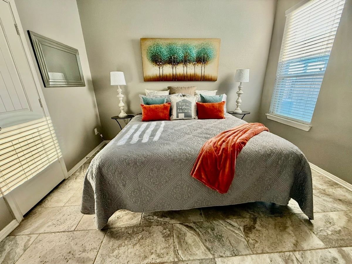 King bedframe, king mattress, mirror, pillows, and picture.