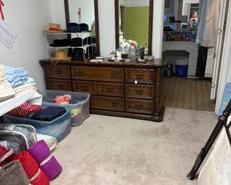 Heavy wooden dresser with mirrors and lots of linens