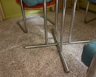 Chrome legs on table with glass and wicker