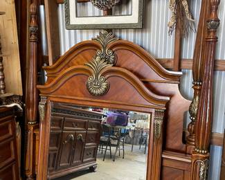 Beautiful wood headboard and footboard and mirror with elegant design and ornate fashioning -