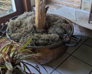 Not sure of the type of metal, but this is a large vessel, with fake banana tree to boot