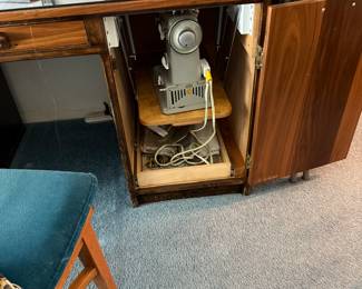 Custom built sewing desk with hideaway cabinet for sewing machine. 