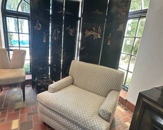 One of two accent chairs on casters