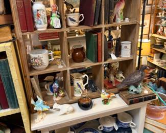 Books, blue and white dishes, bird statue, teapot
