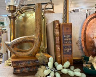 brass candlesticks with globes, old books, jade grapes, copper tray