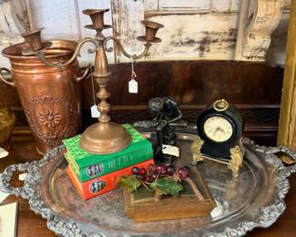 Gorgeous silvery tray with beautiful decorative edge and feet, candleabra, copper vase, clock, grapes and old books