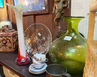 large green glass vase, swung base, brass cherubs