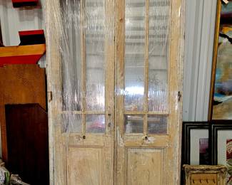Set number two of double hung French doors. Missing glass panel in one section. 
