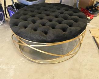Round black stuffed metal oberaided ottoman 